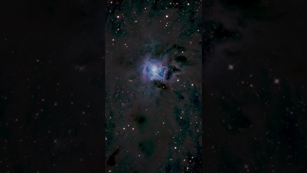 The blue Iris Nebula amid a deep field of stars